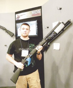 Jonathan Hart holding the MOA modified Stoeger 3000 fitted with the Roth XRail high-capacity magazine. 