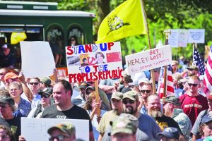 (Boston,MA 07/23/16) Attendees hold signs  on Saturday,July 23, 2016 at statehouse rally in opposition to the recent actions of attorney general Maura Healy. Staff photo by Patrick Whittemore.